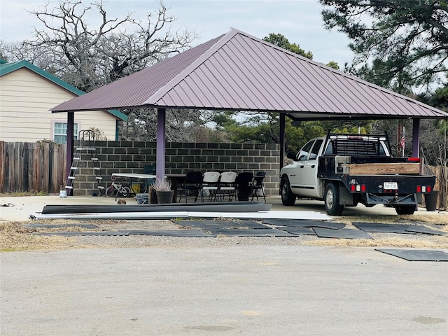 view of property's community featuring a carport and fence