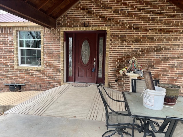 doorway to property with brick siding and crawl space