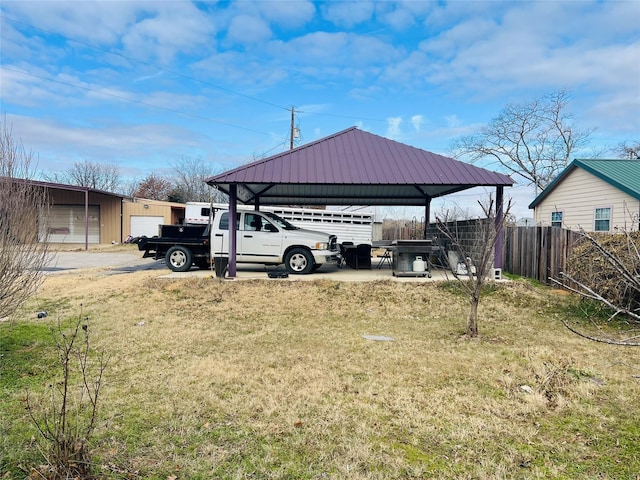 view of yard featuring an outdoor structure and fence