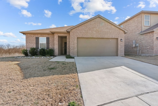 ranch-style home with concrete driveway, brick siding, an attached garage, and a front yard