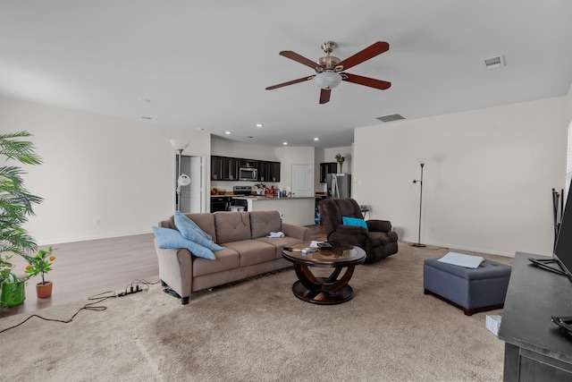 living area with light wood finished floors, visible vents, a ceiling fan, and recessed lighting