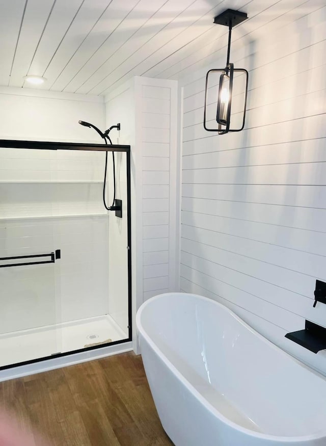 bathroom with plus walk in shower and hardwood / wood-style floors