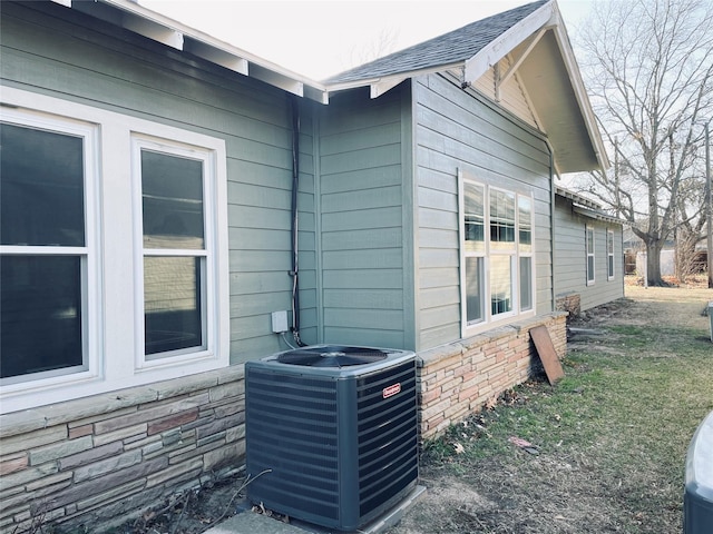 view of home's exterior with central AC unit