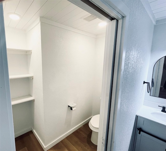 bathroom with vanity, hardwood / wood-style flooring, and toilet