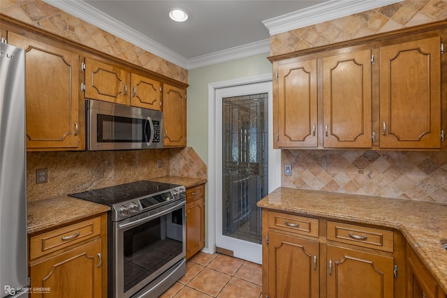 kitchen featuring light tile patterned flooring, appliances with stainless steel finishes, decorative backsplash, ornamental molding, and light stone counters