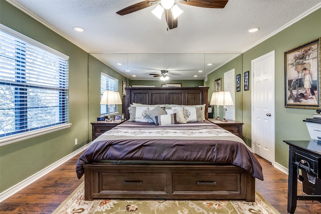 bedroom featuring wood-type flooring, ornamental molding, a textured ceiling, and ceiling fan