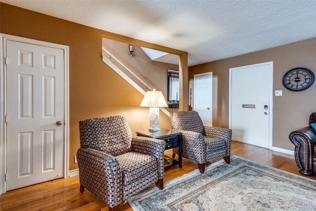 living area featuring hardwood / wood-style floors and a textured ceiling