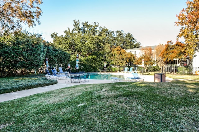 view of swimming pool featuring a yard and a patio area