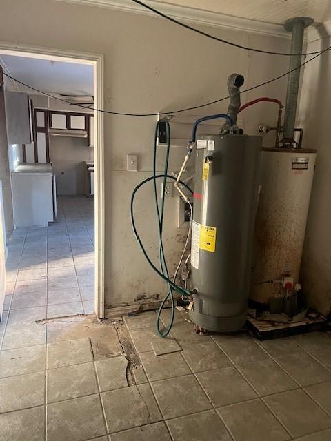 utility room featuring water heater and gas water heater