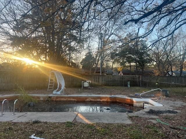 view of pool at dusk