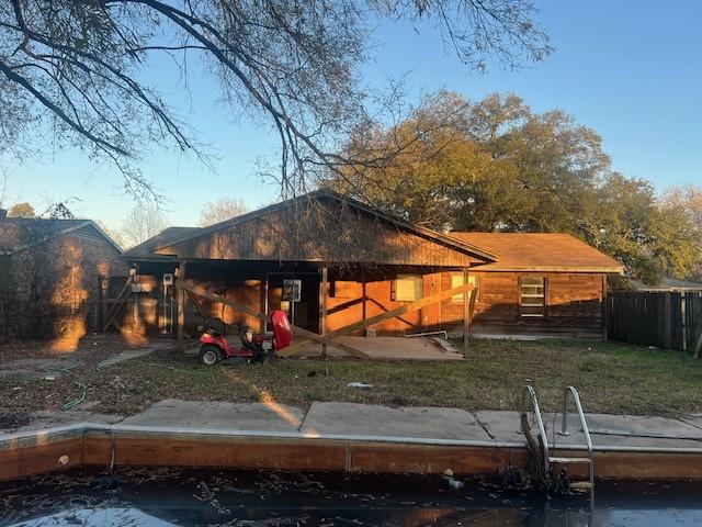 rear view of property with a yard