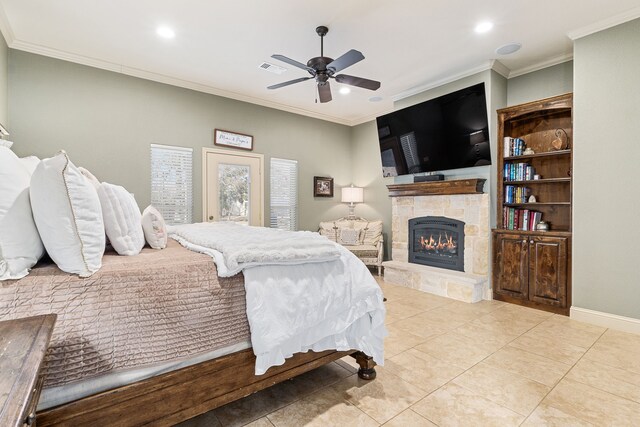 bedroom with crown molding, ceiling fan, light tile patterned flooring, a stone fireplace, and access to outside