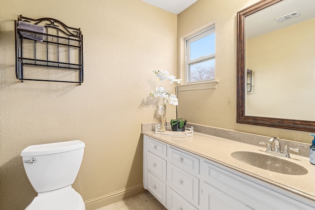 bathroom featuring vanity and toilet