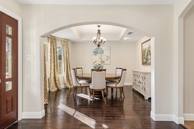 dining room featuring a raised ceiling