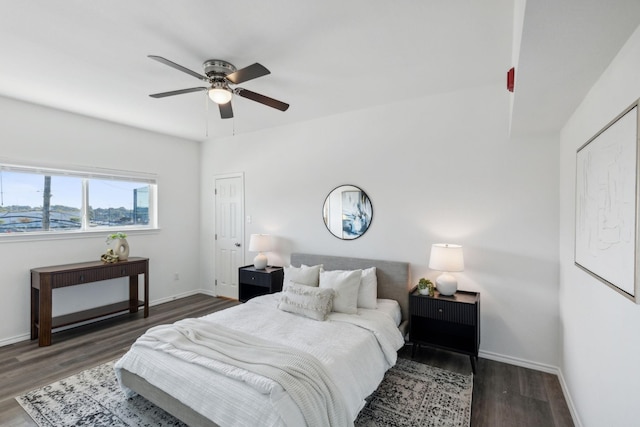 bedroom with dark hardwood / wood-style flooring and ceiling fan