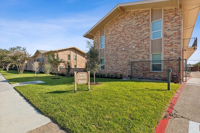 view of side of property with a yard