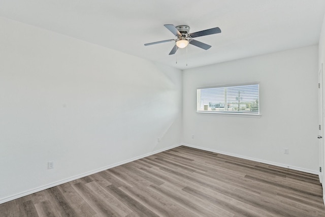 unfurnished room featuring hardwood / wood-style floors and ceiling fan