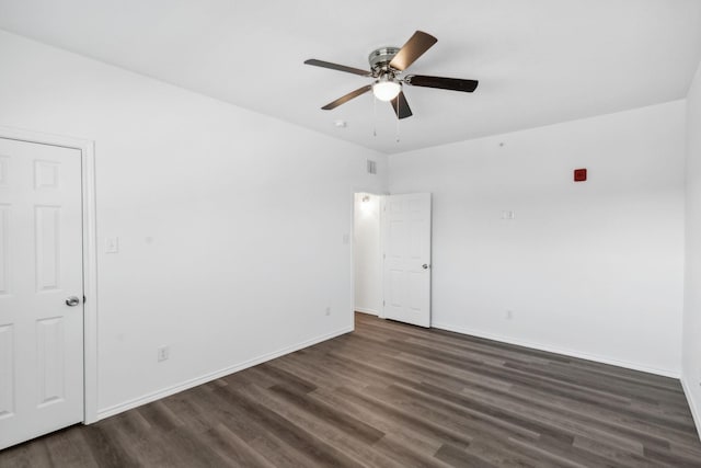 unfurnished room with ceiling fan and dark hardwood / wood-style flooring