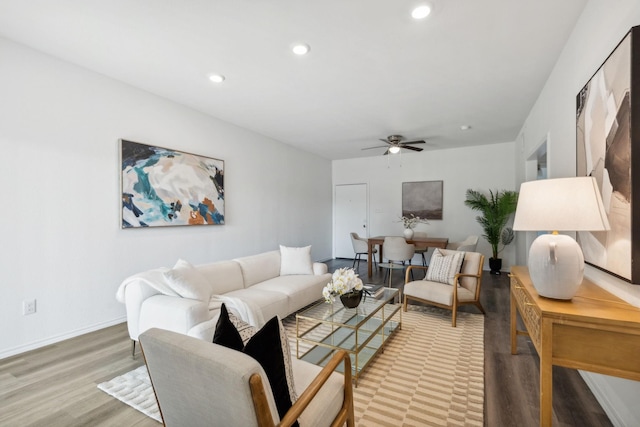 living room featuring ceiling fan and light wood-type flooring