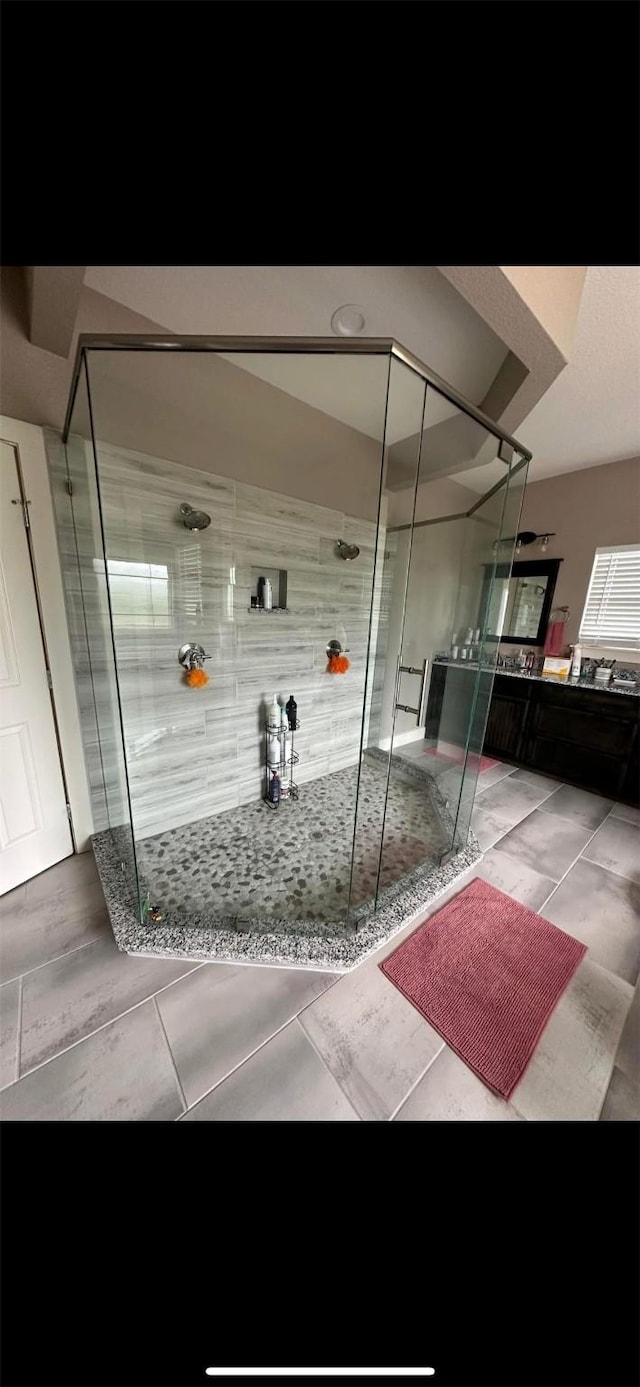 bathroom featuring an enclosed shower and tile patterned floors