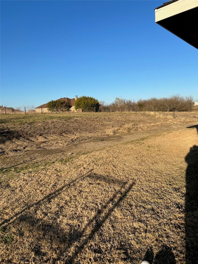 view of yard with a rural view