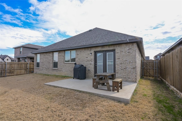 back of house featuring a patio and a yard