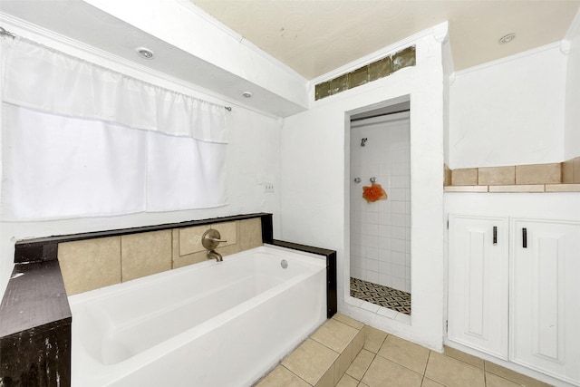 bathroom featuring plus walk in shower and tile patterned floors