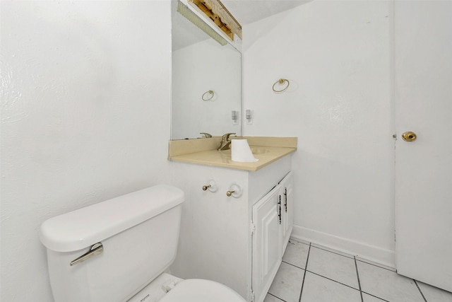 bathroom featuring vanity, tile patterned floors, and toilet