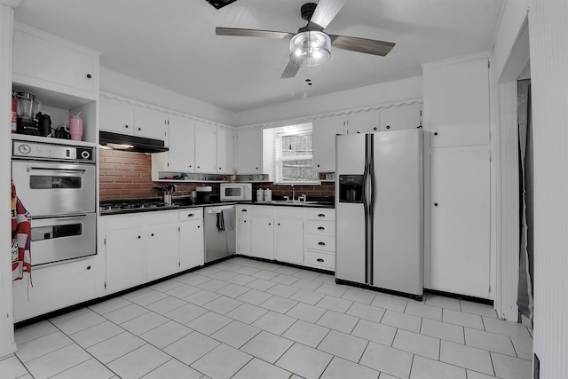 321 Bowles Ct, Kennedale, TX 76060 - kitchen featuring dark countertops, a ceiling fan, under cabinet range hood, and white appliances