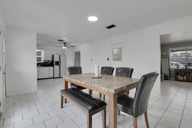 dining area featuring light tile patterned floors and ceiling fan