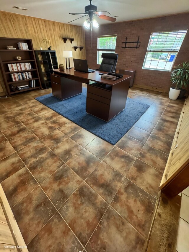 321 Bowles Ct, Kennedale, TX 76060 - office featuring brick wall, wood walls, ceiling fan, and a healthy amount of sunlight