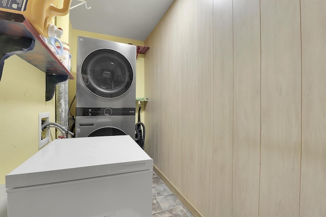 laundry room with stacked washer / dryer