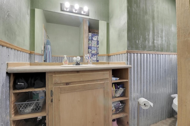 321 Bowles Ct, Kennedale, TX 76060 - bathroom featuring toilet, vanity, and a wainscoted wall