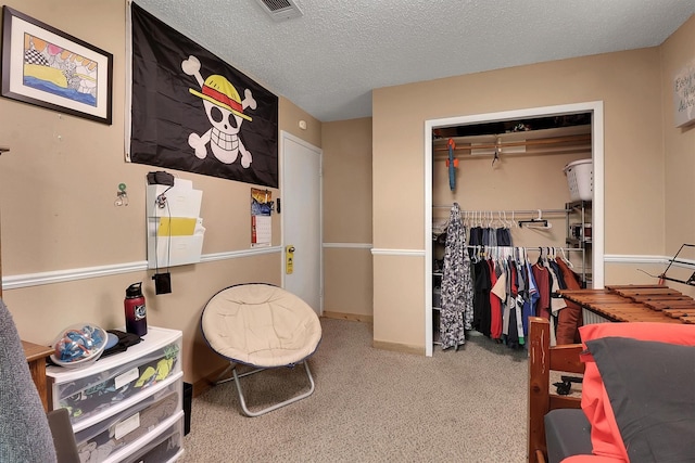 bedroom featuring carpet floors, a textured ceiling, and a closet