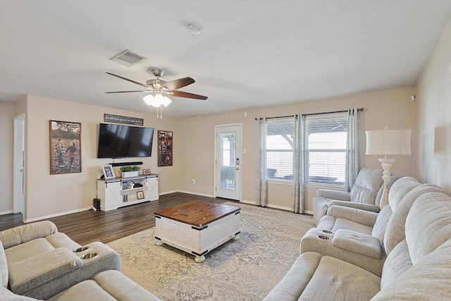 living room featuring wood-type flooring and ceiling fan