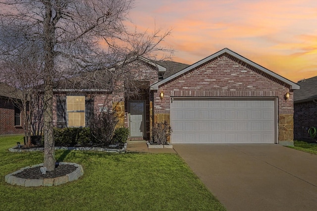 single story home with an attached garage, a front lawn, concrete driveway, and brick siding