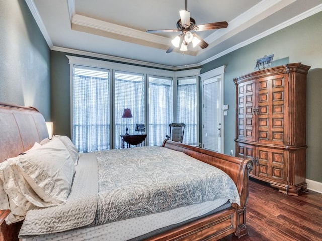 bedroom with a raised ceiling, ornamental molding, dark hardwood / wood-style floors, and ceiling fan