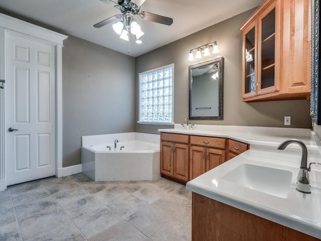 bathroom with ceiling fan, vanity, and a bath