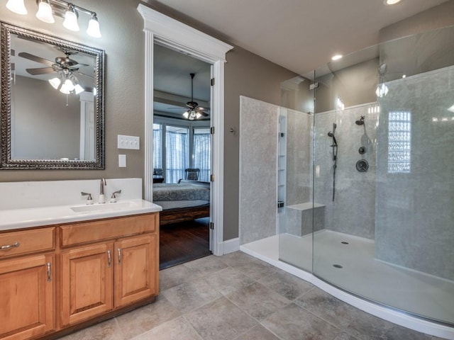 bathroom featuring vanity, ceiling fan, and tiled shower