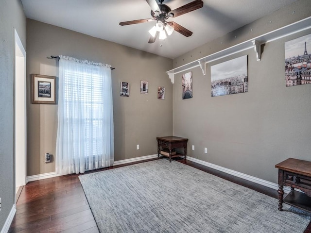 unfurnished room with ceiling fan and dark hardwood / wood-style flooring