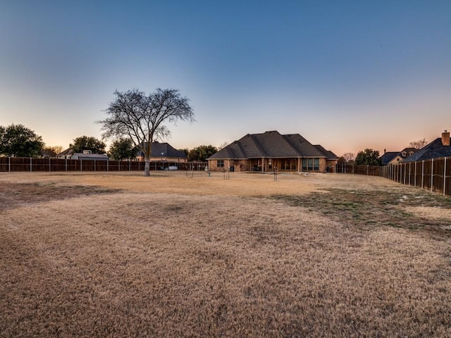 view of yard at dusk