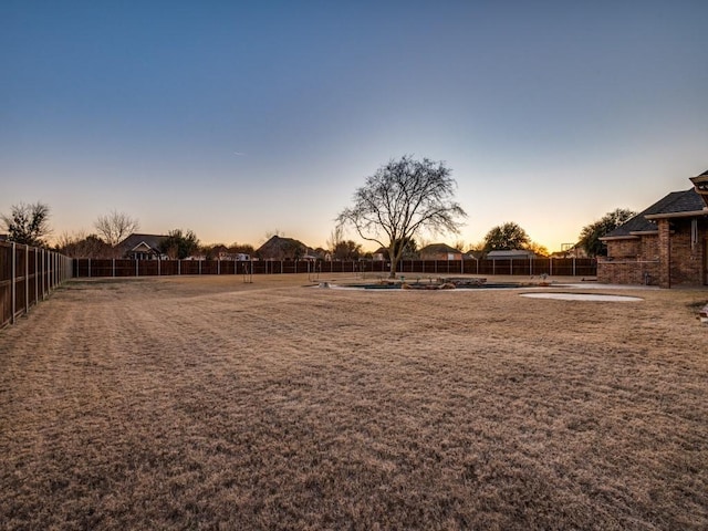 view of yard at dusk