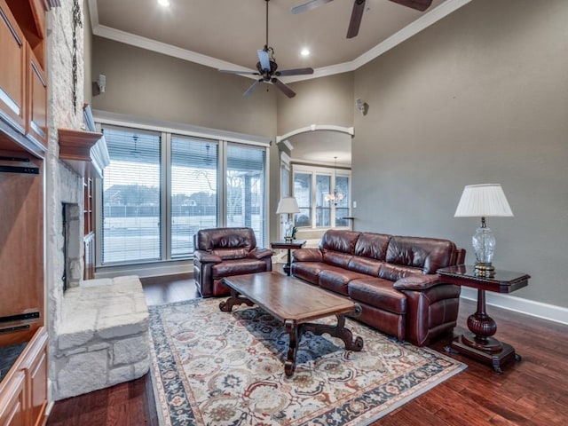 living room featuring crown molding, wood-type flooring, and ceiling fan