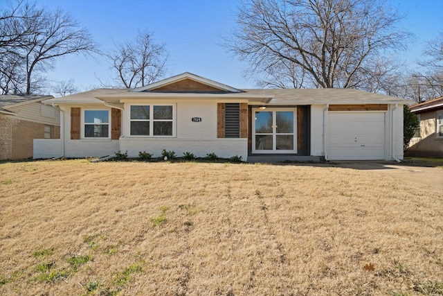 ranch-style home featuring a garage, dirt driveway, brick siding, and a front lawn