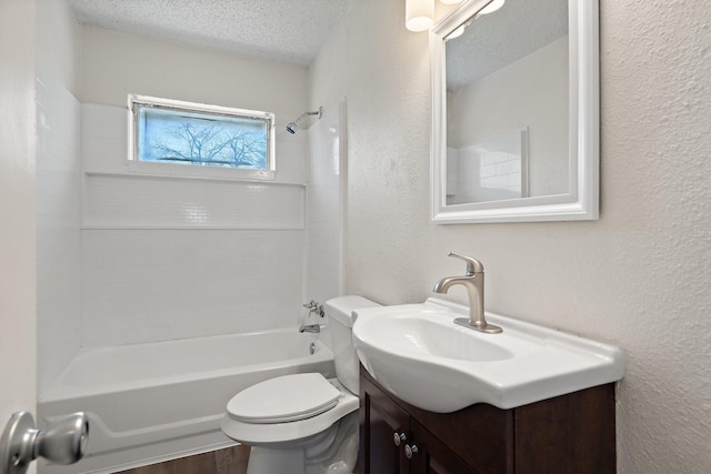 bathroom featuring a textured ceiling, a textured wall, toilet, vanity, and  shower combination