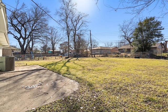 view of yard featuring a patio area, fence, and central AC