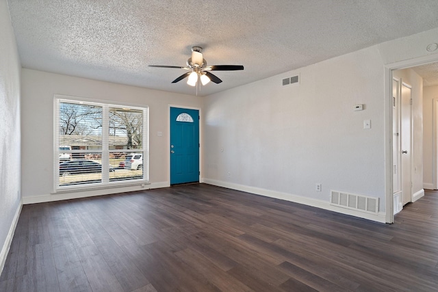 foyer featuring a ceiling fan, a textured ceiling, visible vents, and dark wood-style flooring