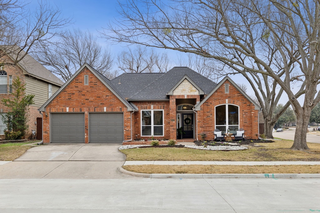 view of front of house with a garage and a front lawn