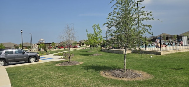 view of property's community with a yard