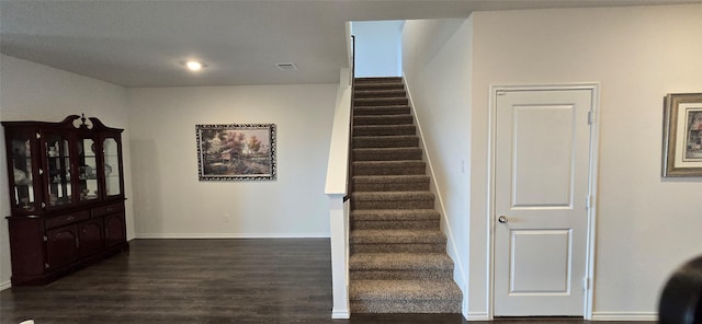 staircase featuring wood-type flooring